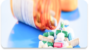 A medicine bottle on the table with a capsule coming out of it. building