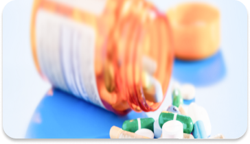 A medicine bottle on the table with a capsule coming out of it. achive